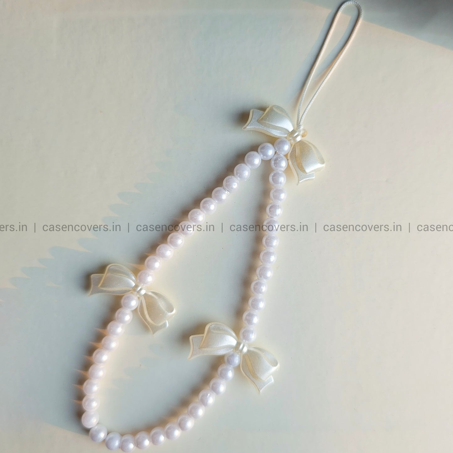 The Wings Bow and Pearl Charm